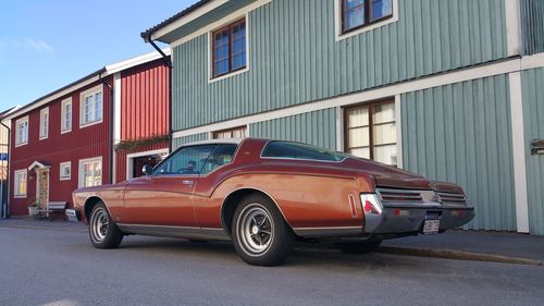 Car on street against buildings in city