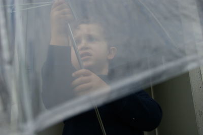 View of boy with umbrella