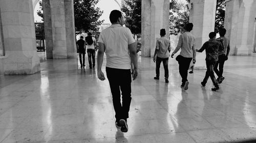 Rear view of men walking on street