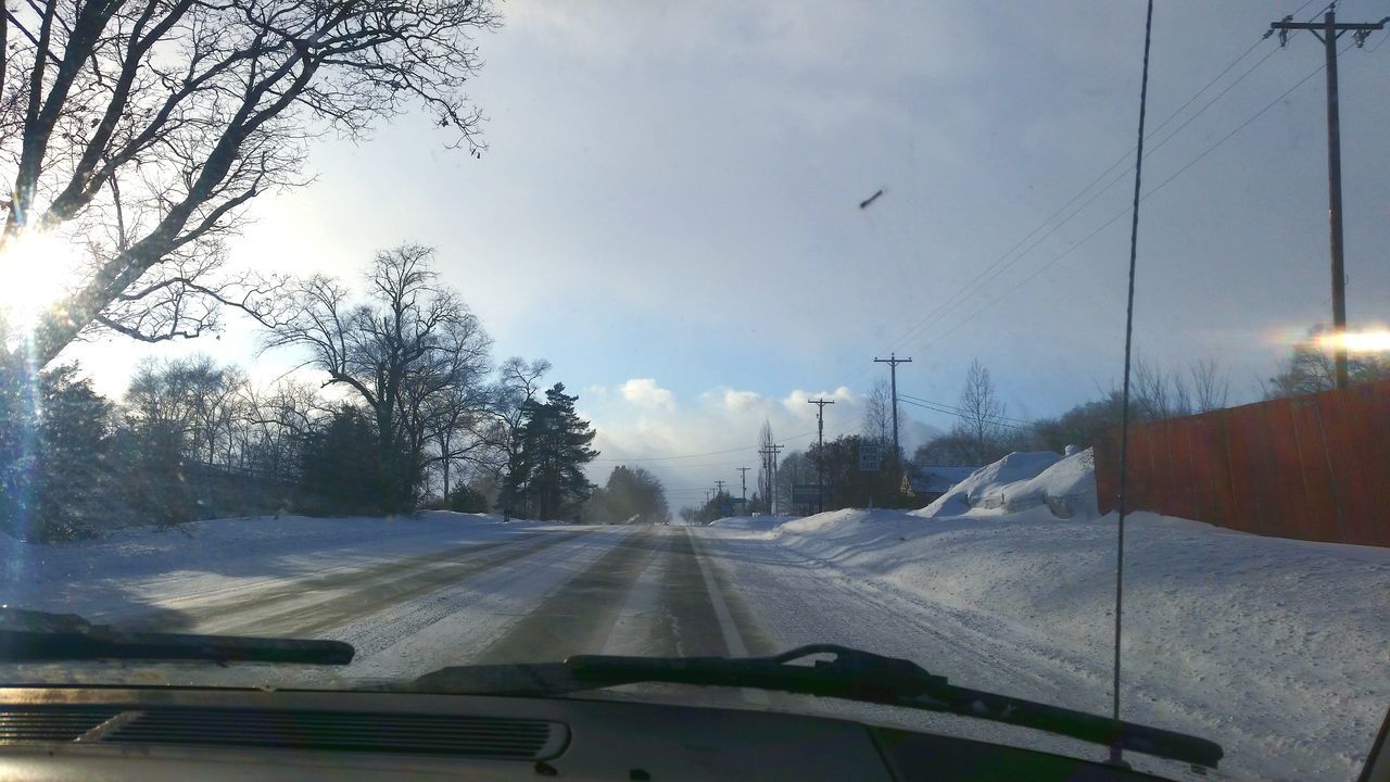 transportation, snow, road, car, winter, mode of transport, the way forward, cold temperature, tree, land vehicle, windshield, weather, season, sky, diminishing perspective, road marking, vehicle interior, nature, vanishing point, travel