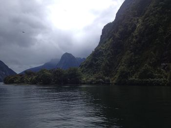 Scenic view of lake and mountains against sky