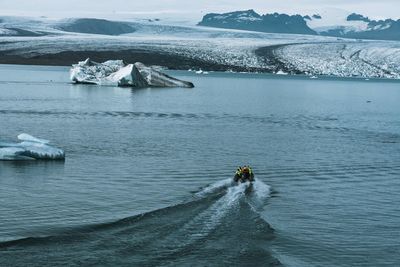 High angle view of person motorboating in lake during winter