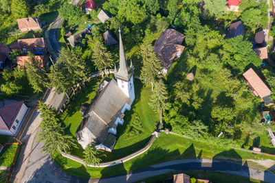 Aerial drone point of view of a whitewashed protestant church in manastireni, transylvania, romania