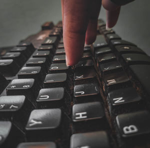 Cropped hand using computer keyboard