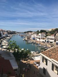 High angle view of houses by sea against sky