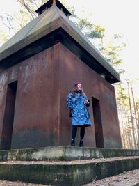 Full length of man standing by building