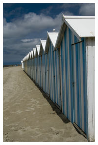 Lifeguard hut on beach against sky