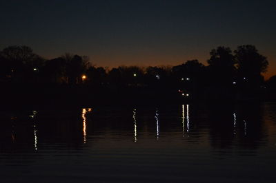 Scenic view of lake against sky at night