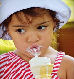 Close-up portrait of cute boy drinking ice cream