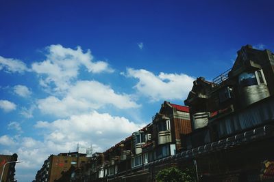 Low angle view of building against cloudy sky