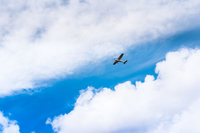 Low angle view of airplane flying in sky