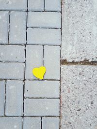 High angle view of yellow heart shape on footpath