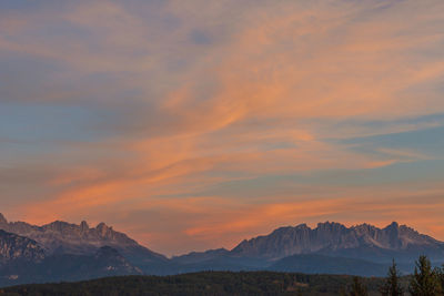 Scenic view of snowcapped mountains against sky during sunset