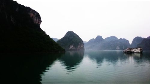 Scenic view of lake and mountains against clear sky