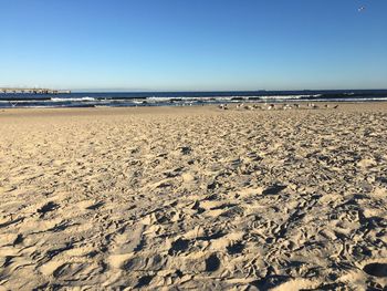 Scenic view of beach against clear sky