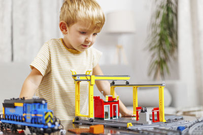 Portrait of cute girl playing with toy at home