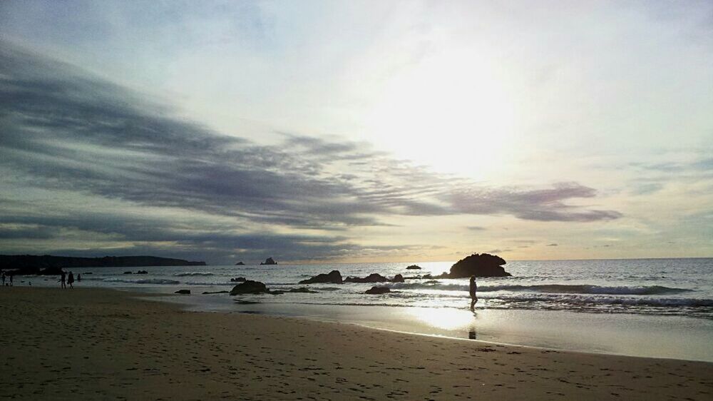 SILHOUETTE BEACH AGAINST SKY DURING SUNSET