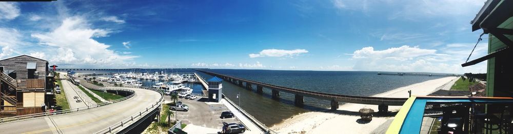 Panoramic view of city by sea against sky