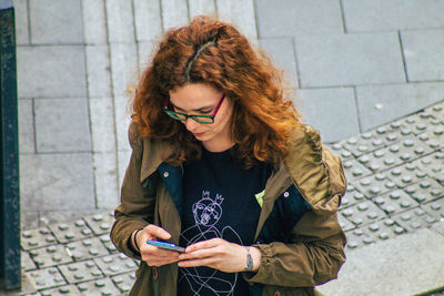 Young woman using mobile phone outdoors