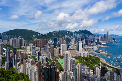 Buildings in city against cloudy sky