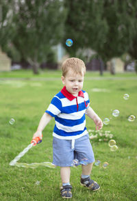 Full length of a boy with bubbles
