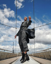 Low angle view of man standing against sky