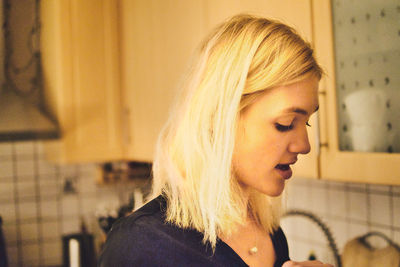 Close-up portrait of young woman at home