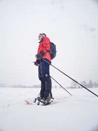 Man skiing on snow against mountain