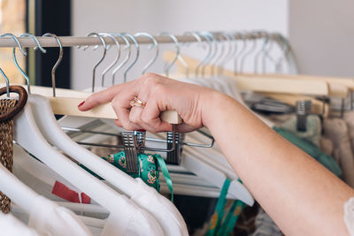 Cropped hand of woman choosing clothes