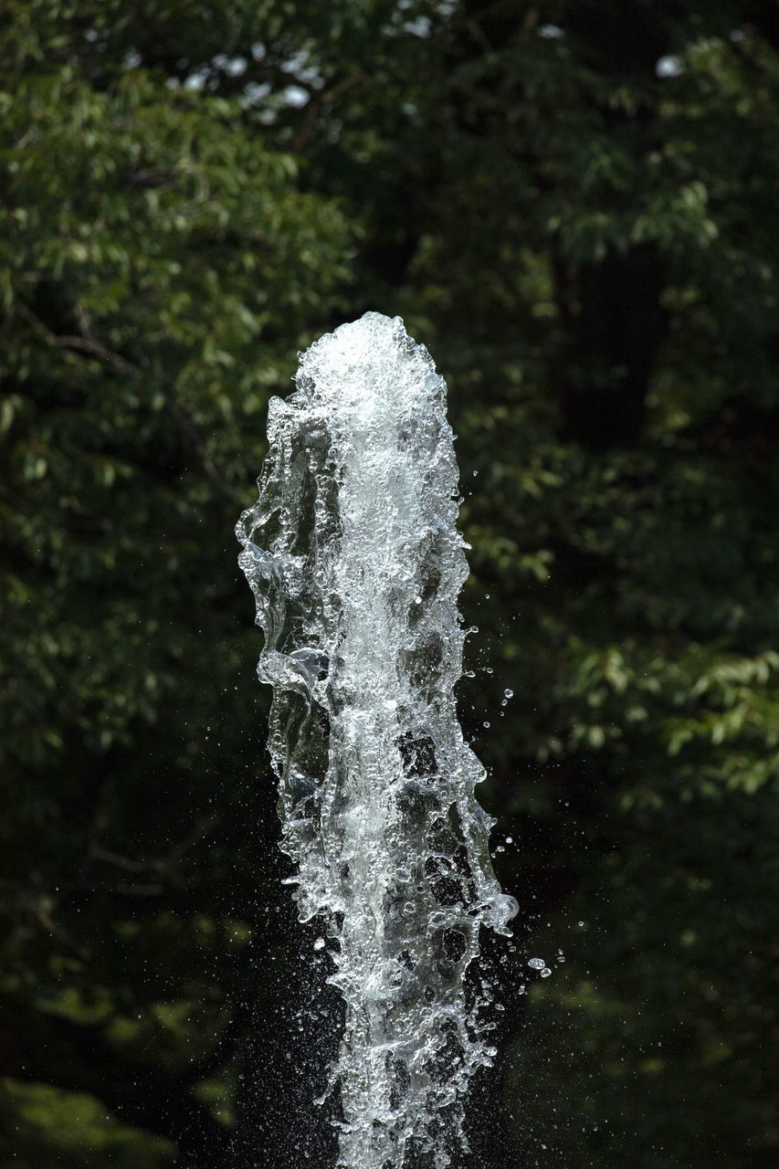 CLOSE-UP OF WATER SPLASHING ON ROCK