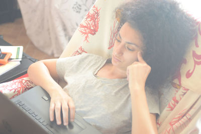 Midsection of woman using pc at home