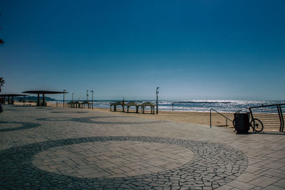 Scenic view of beach against clear blue sky