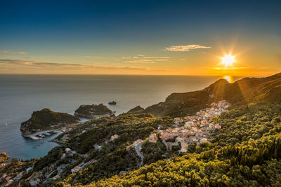 Scenic view of sea and mountains during sunset