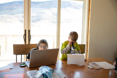 Boy and girl working on school work at home