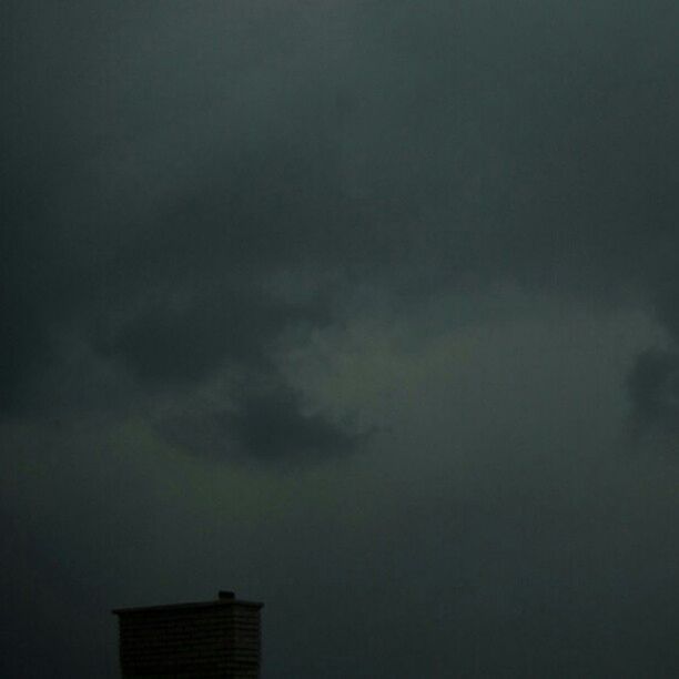 low angle view, sky, building exterior, cloud - sky, built structure, architecture, weather, cloudy, overcast, silhouette, high section, dusk, storm cloud, outdoors, nature, no people, copy space, building, cloud, beauty in nature