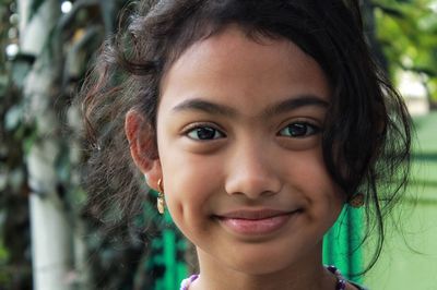 Close-up portrait of smiling young woman