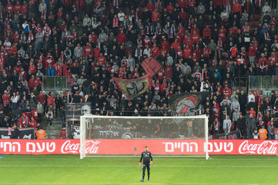 Group of people walking on soccer field