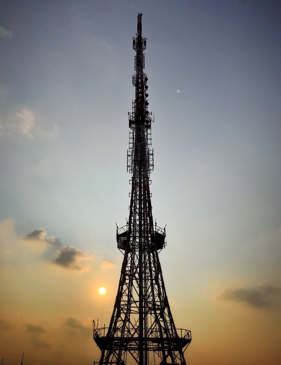 technology, tower, communication, tall - high, connection, metal, sky, sunset, telecommunications equipment, satellite dish, wireless technology, no people, low angle view, global communications, outdoors, cloud - sky, silhouette, antenna - aerial, architecture, built structure, day, nature, drilling rig