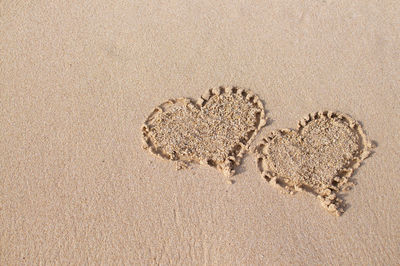 High angle view of footprints on sand at beach