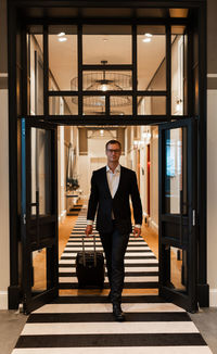 Portrait of man standing in corridor