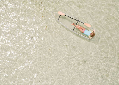 High angle view of woman in inflatable raft at sea
