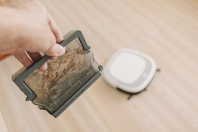 High angle view of person holding coffee cup on table