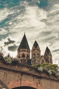 Buildings against cloudy sky