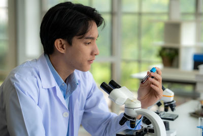 Side view of doctor examining patient in laboratory