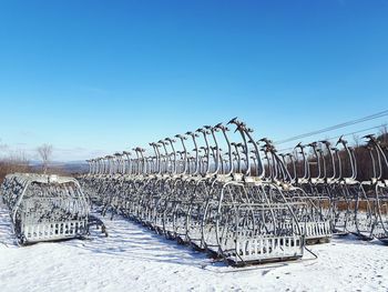 Metallic structure in row against clear blue sky