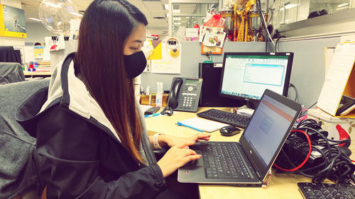 Side view of woman using mobile phone