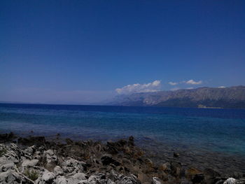 Scenic view of sea against blue sky