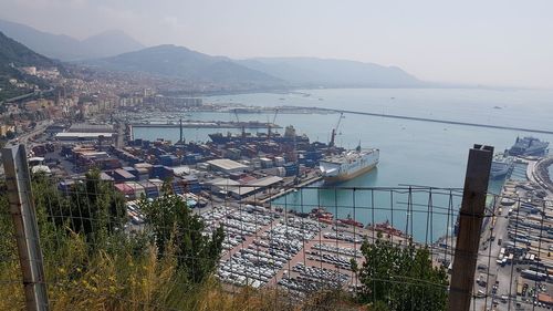 High angle view of townscape by sea against sky