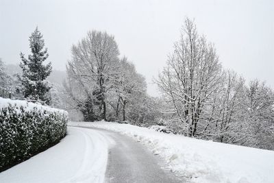 Road passing through snow covered landscape