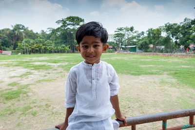 Portrait of boy standing by plants